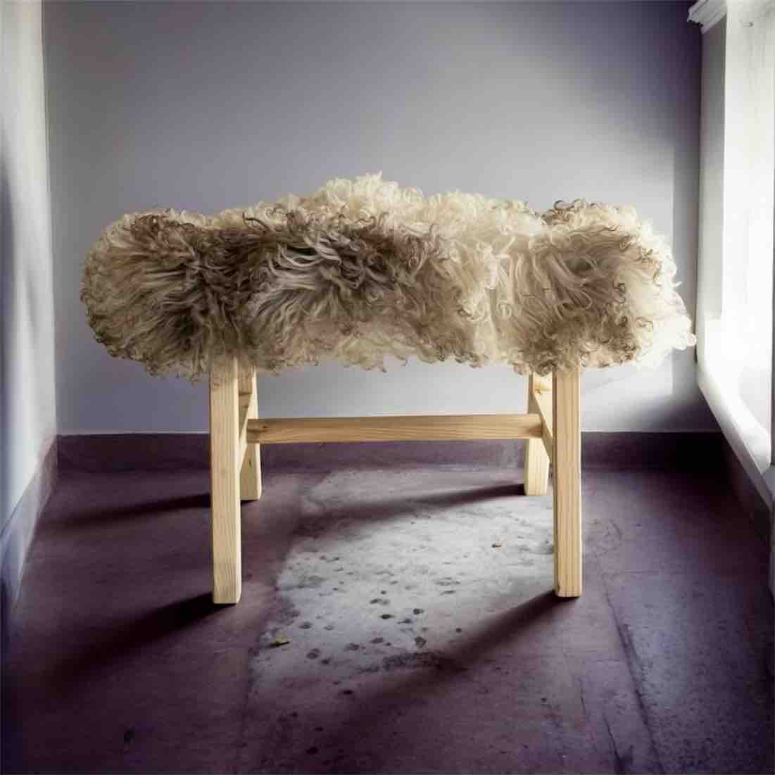 Bench with fluffy beige cushion on a plain background