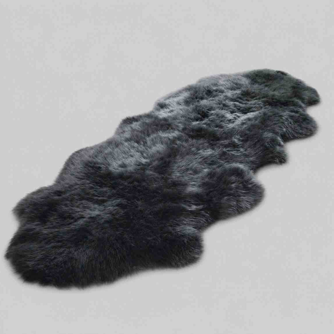 Dark gray fur rug on a light gray background