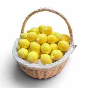 Basket filled with lemons on a white background