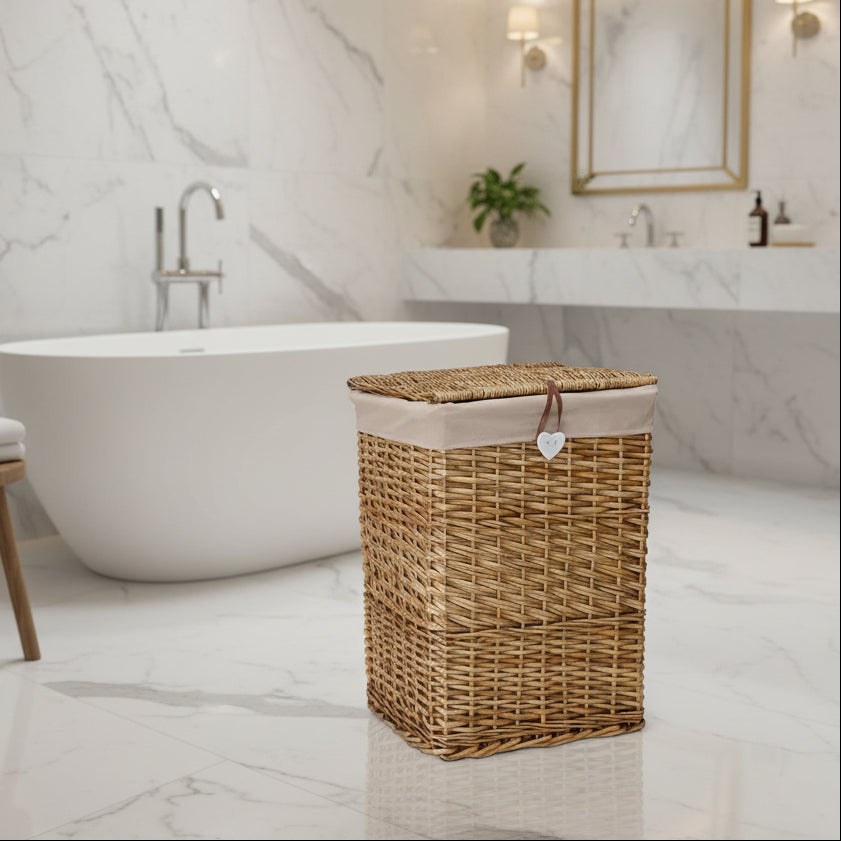Wicker laundry basket with a beige lid and heart-shaped tag on a white background