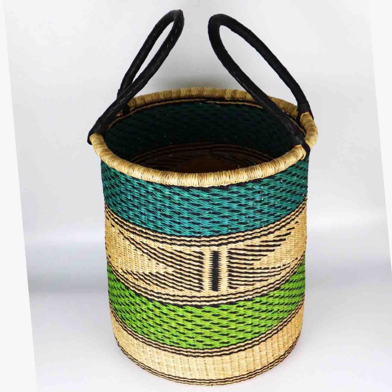 Woven basket with green and black pattern on a white background