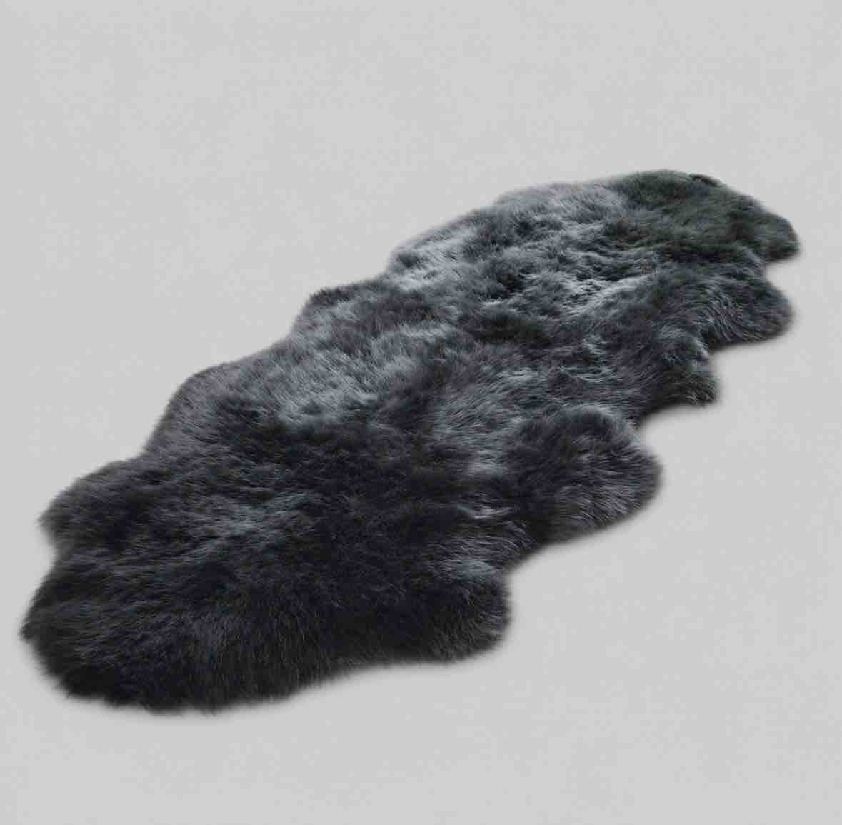 Dark gray fur rug on a light gray background