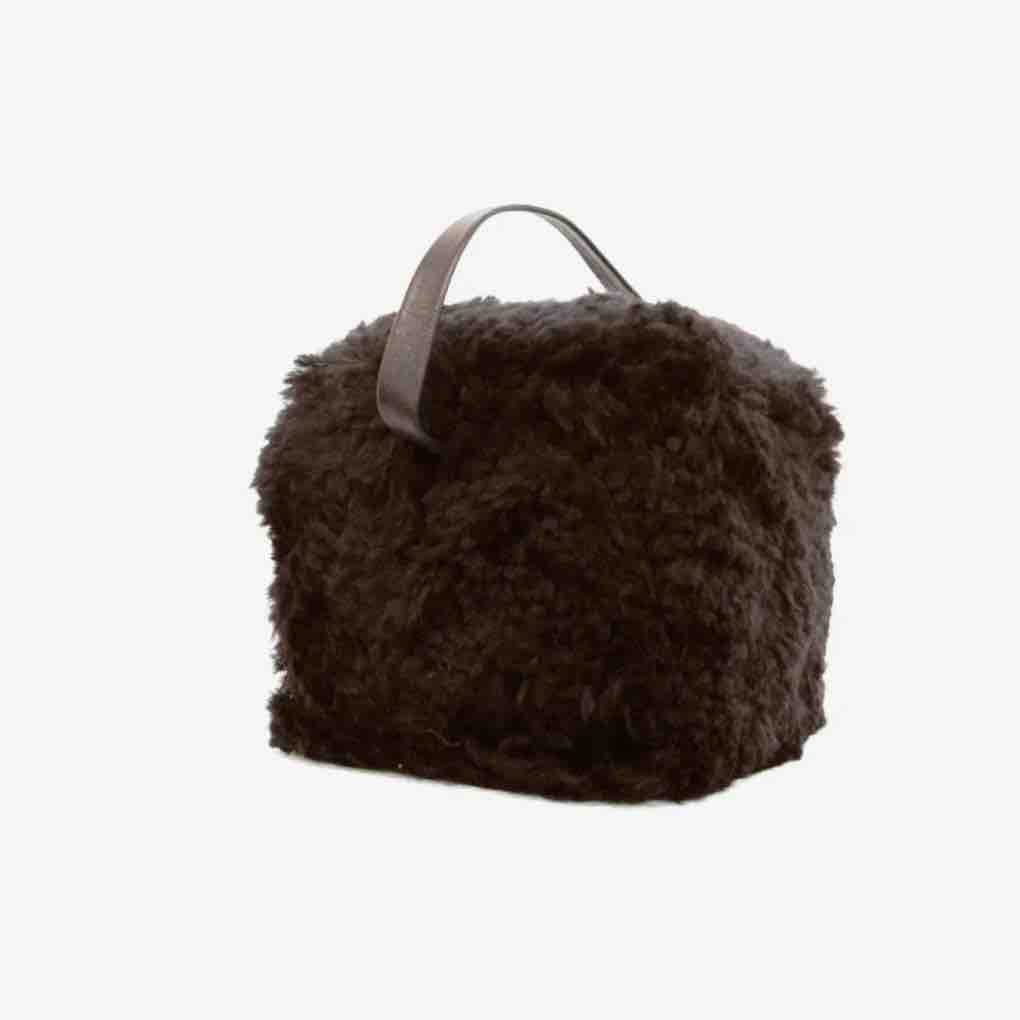 Brown fluffy bag with a handle on a white background