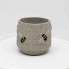 Concrete cup with bee designs on a white background