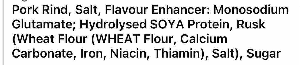 A close-up of a text label listing pork rind, salt, flavour enhancer, hydrolysed SOYA protein, rusk, wheat flour, calcium carbonate, iron, niacin, thiamin, and sugar.