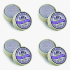 Multiple bars of Savon Artisanal soap with purple labels on a white background