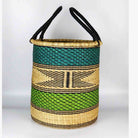 Woven basket with black handles on a white background