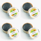 Set of four artisanal soaps with labels on a white background