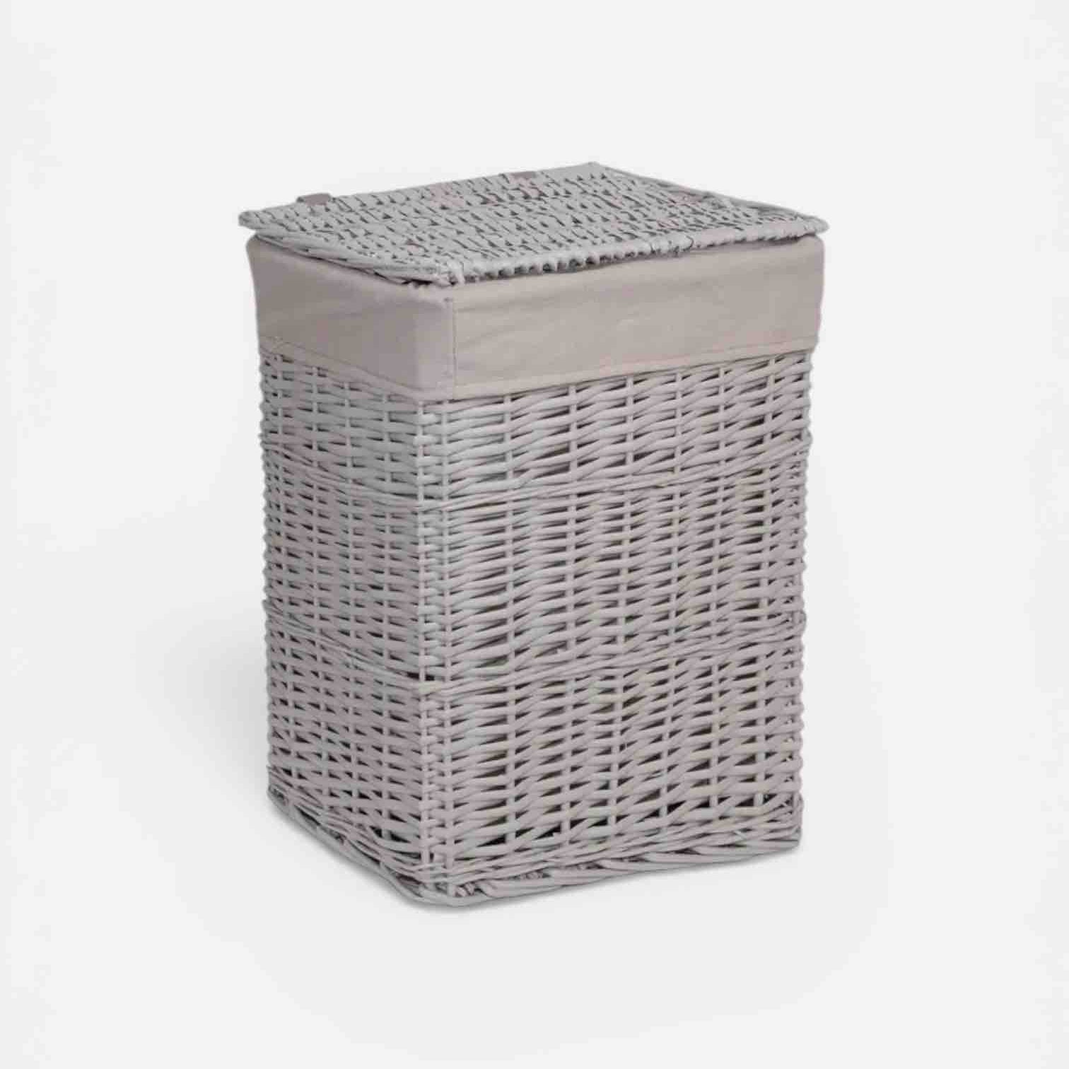 Gray wicker laundry basket with a lid on a white background