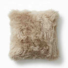 Beige fluffy pillow on a white background