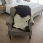 Gray armchair with a brown and white fur throw in a room setting.