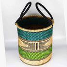 Woven basket with green and black pattern on a white background