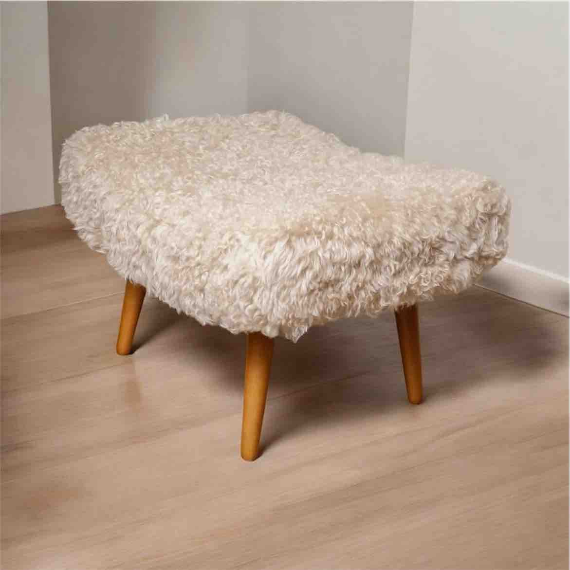 Stool with white fluffy cover on a wooden floor