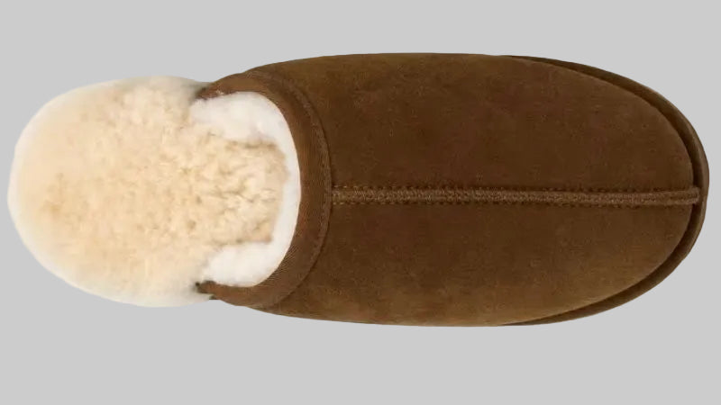 A single brown suede slipper with a fluffy cream shearling lining, shown from a top-down view on a white background.