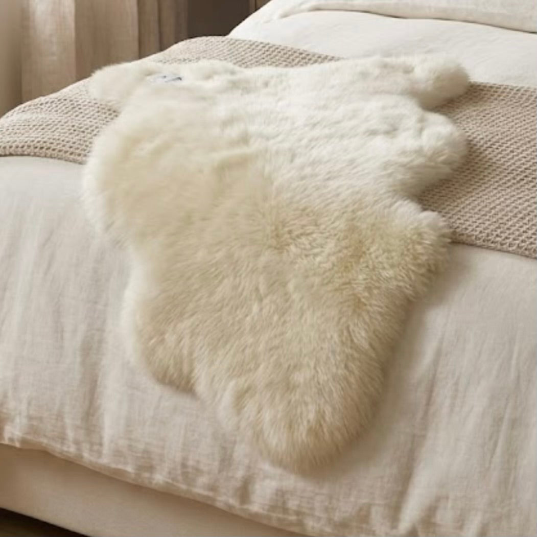 White fur rug on a textured surface