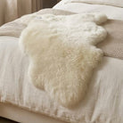 White fur rug on a textured surface