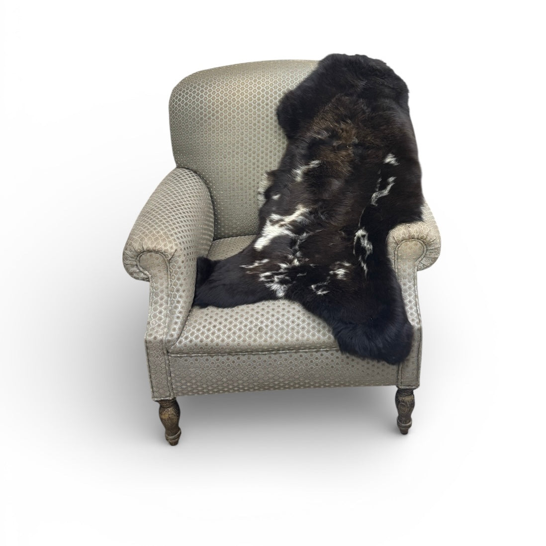 Chair with a sheepskin  rug on a white background